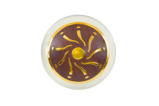 Decorative circular object with gold and brown design on a white background